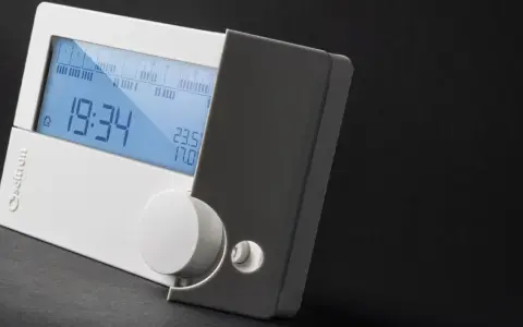 Cronotermostato cos'è? Un dispositivo digitale bianco con display blu che mostra ora, temperatura e programmazione.