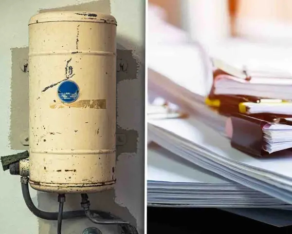 Vecchia caldaia arrugginita e pile di documenti. Pronti per lo smaltimento caldaie e la gestione burocratica.